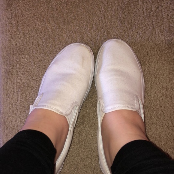 white vans slip ons on feet